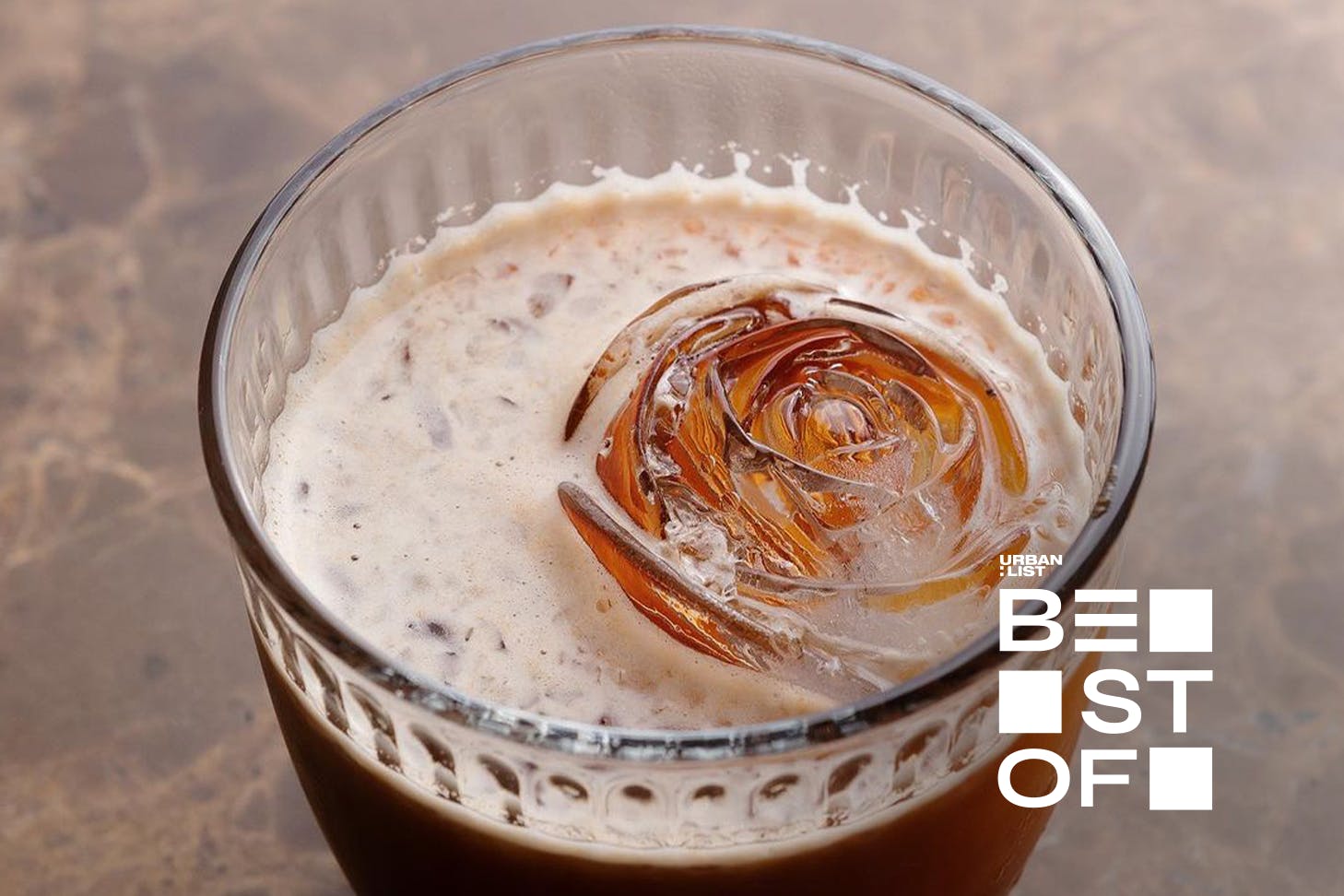 A rose-shaped ice cube in a cocktail